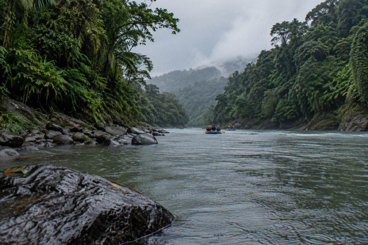 Rain clouds drifting over a jungle river gorge with green rainforest on both banks