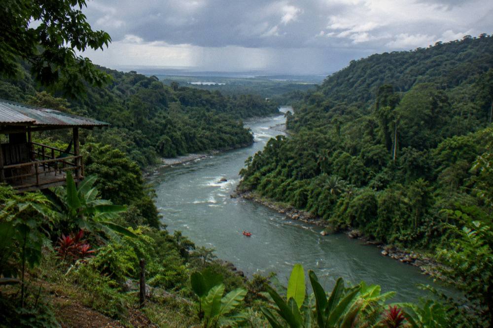 A river map view of a green canyon corridor winding toward distant lowlands