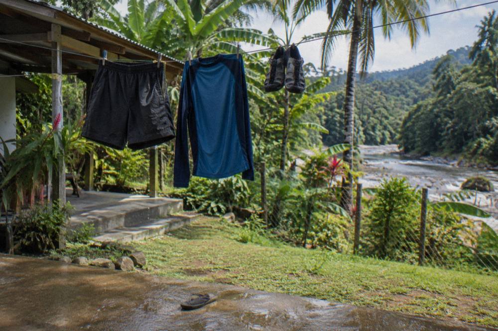 Quick-dry rafting clothes and water shoes drying on a line in the sun