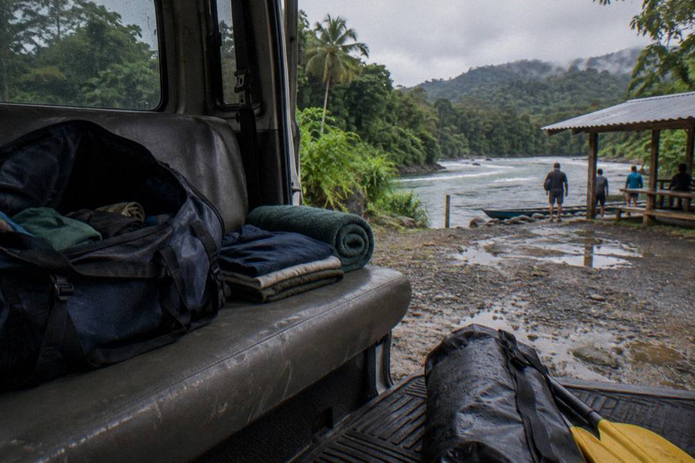 Dry clothes and a towel packed in a bag waiting in a vehicle at a river take-out